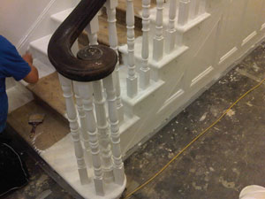 Man painting gloss on stairs